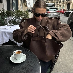 Women's dark mocha brown leather tote bag styled in a classic Parisian street scene
