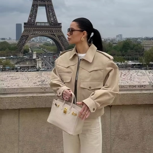 Chic beige faux suede utility jacket with large pockets against Eiffel Tower backdrop