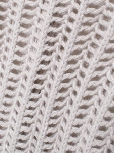 Macro detail of soft light grey chunky knit fabric with textured V-shape woven pattern