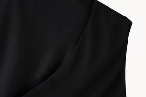 Detail des hochwertigen schwarzen Stoffes und der präzisen Nähte am Neckholder-Ausschnitt