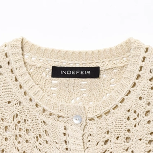 Chic cream openwork crochet knit cardigan with round neck and brand tag detail