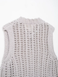Detail of oatmeal chunky knit vest showing the ribbed neckline and hollow weave texture