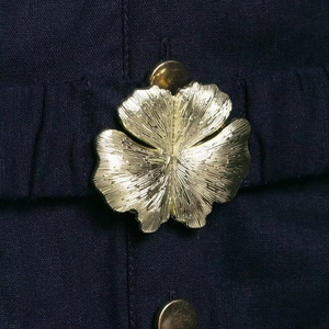 Navy linen midi dress featuring a decorative gold floral metal button with relief texture