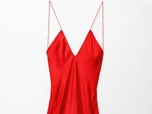 Detail eines roten Satin-Maxikleids mit Spaghettiträgern und tiefem V-Ausschnitt
