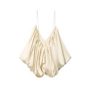 Detail view of champagne satin camisole featuring delicate straps and elegant pleated texture