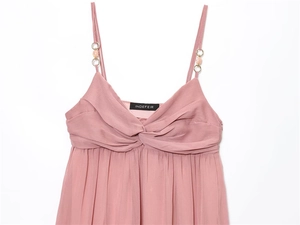 Detail of dusty pink chiffon midi dress with twisted knot chest and beaded straps