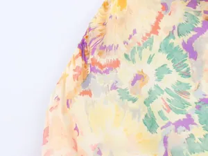 Detailed macro view of soft beige fabric with orange and purple floral abstract print