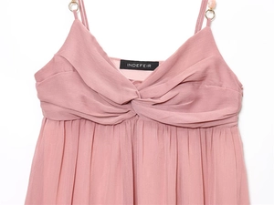 Detail of pink chiffon dress with front twist knot and gold beaded shoulder straps