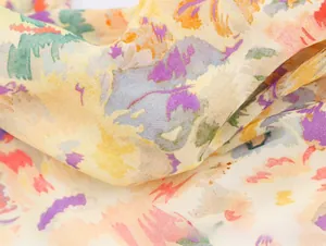 Close-up of lightweight chiffon fabric with abstract purple and orange floral print