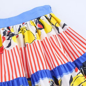 Detailed view of women skirt with lemon print, pleats, and hidden zipper closure