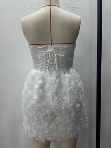 Detail of white tube dress featuring back lace-up closure and 3D floral rose textures