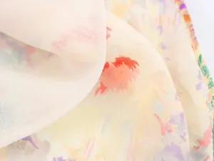 Close-up of floral print chiffon fabric with refined rolled hem and drape details