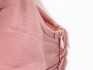 Detail of pink midi dress with micro-pleated fabric texture and hidden side zipper