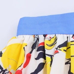 Macro detail of elasticated waist seam on lemon print floral skirt with blue waistband