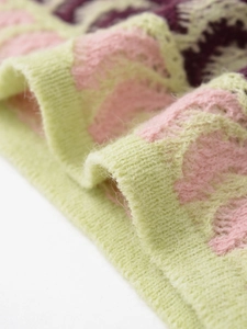 Detail of colorful knit fabric with mohair-like texture and wavy striped pattern
