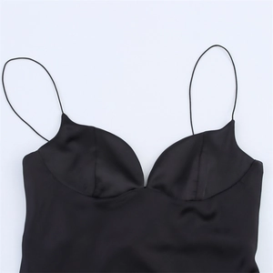 Detail of black satin dress featuring thin spaghetti straps and a sweetheart neckline
