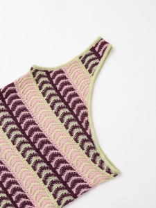Detailed close-up of pink and purple crochet knit texture with scalloped wavy pattern