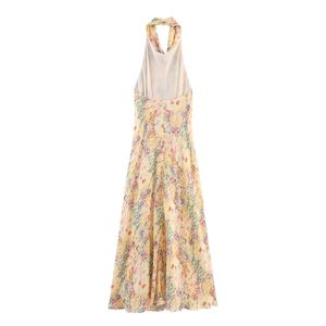 Back view of backless halter floral dress with colorful flower print and A-line silhouette