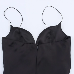 Close-up of black satin dress back featuring thin straps and hidden zipper closure