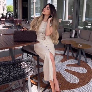 Elegante abito smanicato beige con bottoni e cintura con fibbia tonda stile urbano