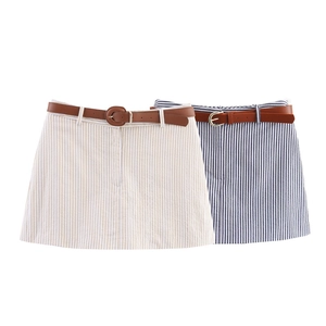 Detail of striped seersucker mini skirts in beige and blue with brown faux leather belts