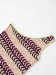 Close-up of crochet knit texture and scalloped edges in pink and green knitwear