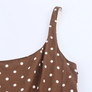 Close-up of polka dot midi dress showing shoulder strap and side invisible zipper detail