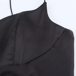 Macro view of silky black satin fabric texture and premium neck stitching details