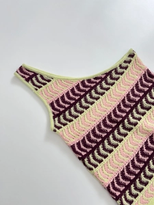 Detailed close-up of the scalloped crochet knit texture in purple and green hues