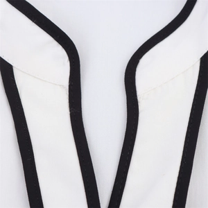Detail of V-neckline with contrasting black trim on a white poplin midi dress