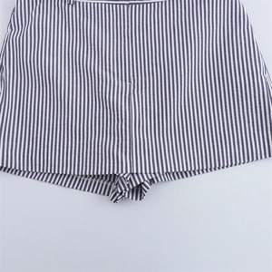 Detailed close-up of the stitching and blue vertical stripes on women's cotton shorts