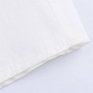 Close-up of fine stitching and high-density fabric texture on white polka dot dress