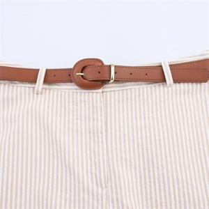 Detail of khaki striped culottes with a brown leather belt and golden metal buckle