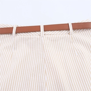 Detail of beige vertical stripe culottes with matching brown faux leather waist belt