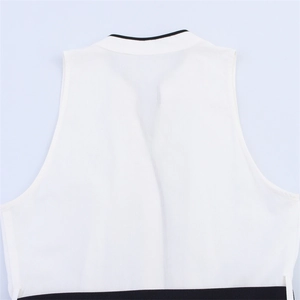 Detail of V-neck sleeveless midi dress featuring white poplin with black contrast trim