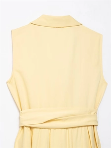 Detail view of light yellow sleeveless shirt dress with a matching belt and notched lapels