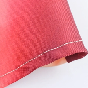 Macro view of red tie-dye satin fabric showing detailed twill texture and stitching