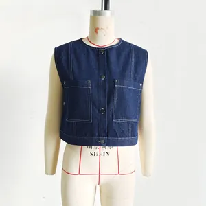 Detail of dark blue denim sleeveless top featuring contrast stitching and button closure