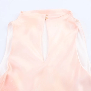 Detail of pink satin midi dress featuring a keyhole back and double button closure