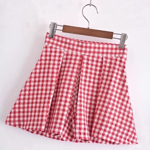 Women's high-waisted red gingham pleated shorts with a crisp textured fabric finish