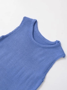 Close-up of blue chunky knit texture and reinforced round neckline on a sleeveless top