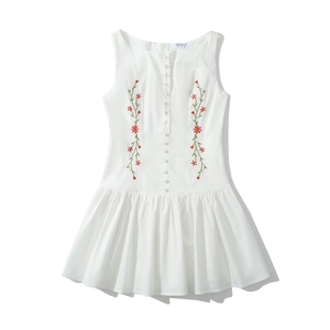 Detail of white sleeveless dress featuring floral embroidery and white button-up front
