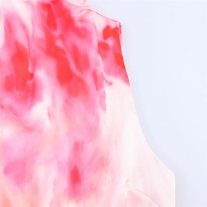 Detailed macro view of the tie-dye satin fabric texture and seams on a midi dress