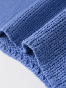 Macro texture view of the blue ribbed knit fabric showing soft fiber details