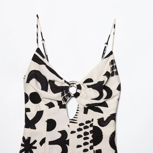 Women's V-neck hollow out floral print camisole top with metal ring detail