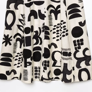 Women hollow design dress with black geometric prints on beige fabric for spring style