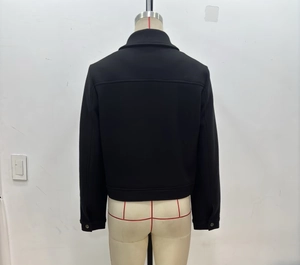 Detail view of black wool-like jacket back featuring shirt collar and silver cuff button