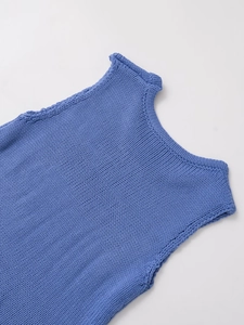 Detail shot of the blue knitted texture and ribbed edges of the one-shoulder top