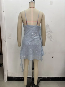 Close-up of light blue sequined dress featuring draped side ruffles and shimmer texture