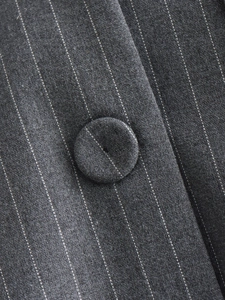 Macro shot of dark grey pinstripe fabric detail with matching fabric-covered button